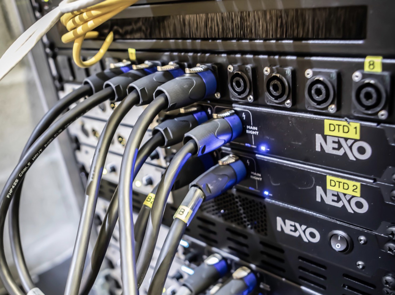 People at a concert facing the stage with various colours of paint powder in the air